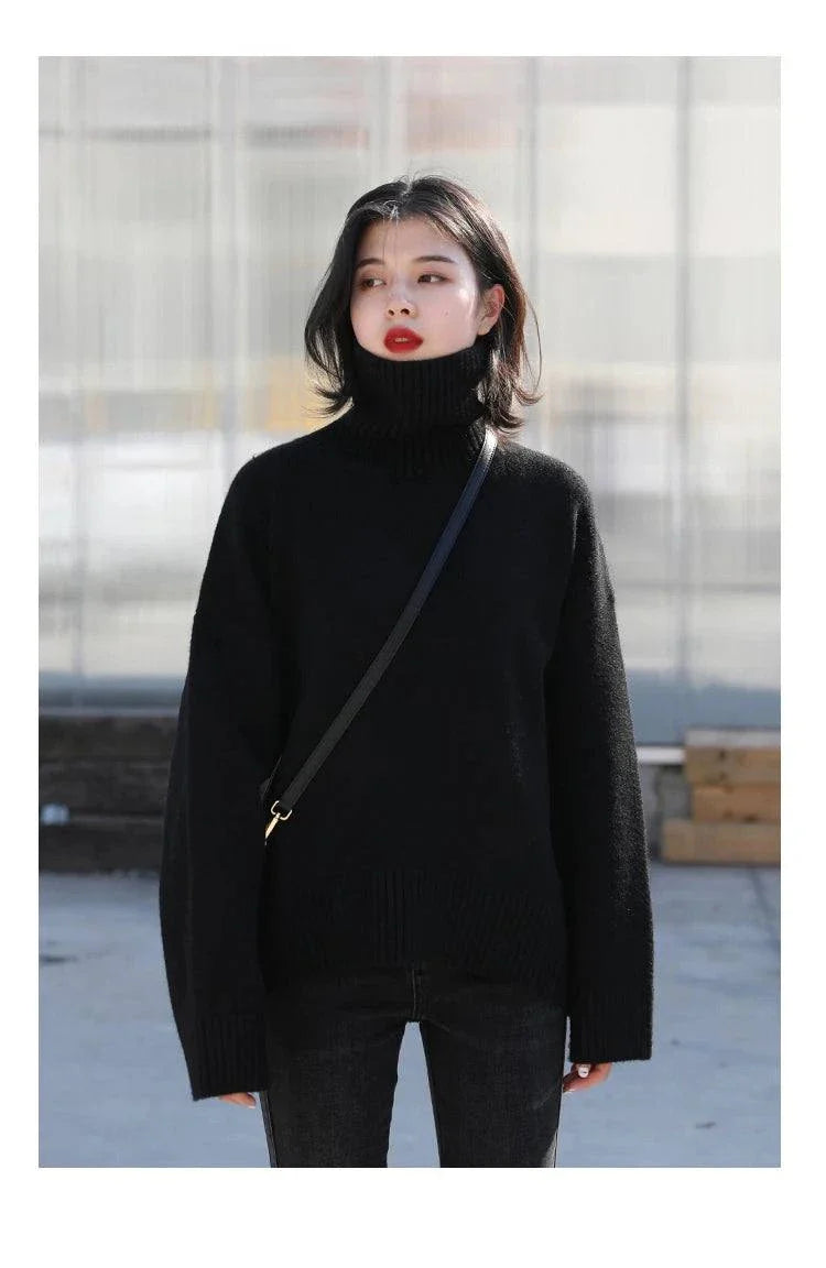 Women's black loose turtleneck sweater in knitwear fabric.