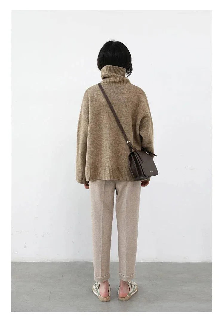 Women's loose turtleneck sweater in solid beige, warm knitwear, autumn winter style.