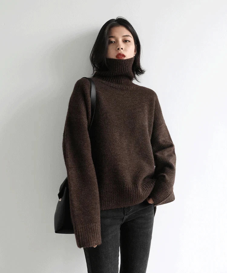 Women's loose turtleneck pullover sweater, solid brown knitwear, full sleeves, cozy winter style.