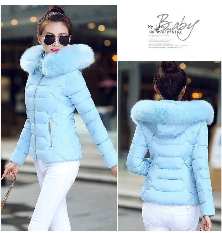 Women's blue winter parka with artificial raccoon fur collar, stylish and warm for 2024.