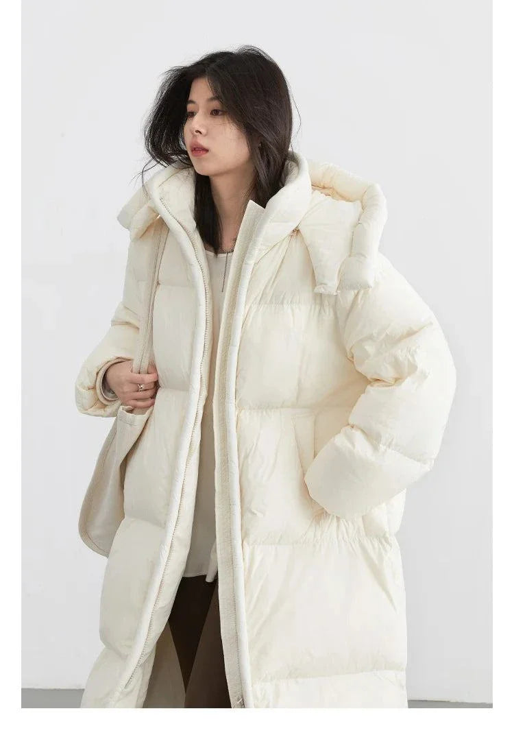 Women's long down coat with detachable hood, thick and warm for autumn and winter, solid color design.