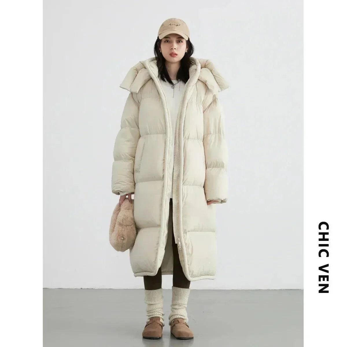 Women's long down coat, thick and warm overcoat for autumn/winter, featuring detachable hood and full zipper closure.