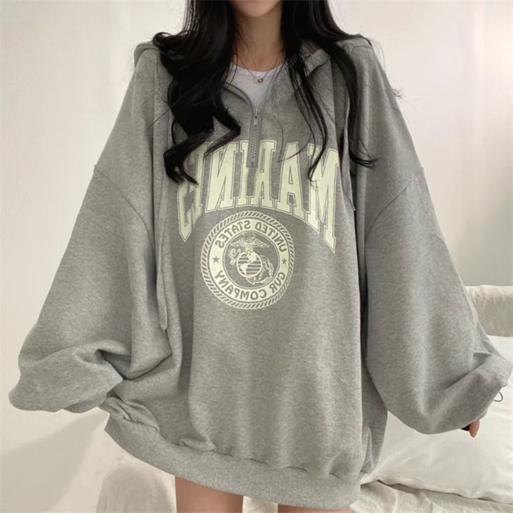 Women's oversized zipper hoodie in grey, casual autumn winter fashion.