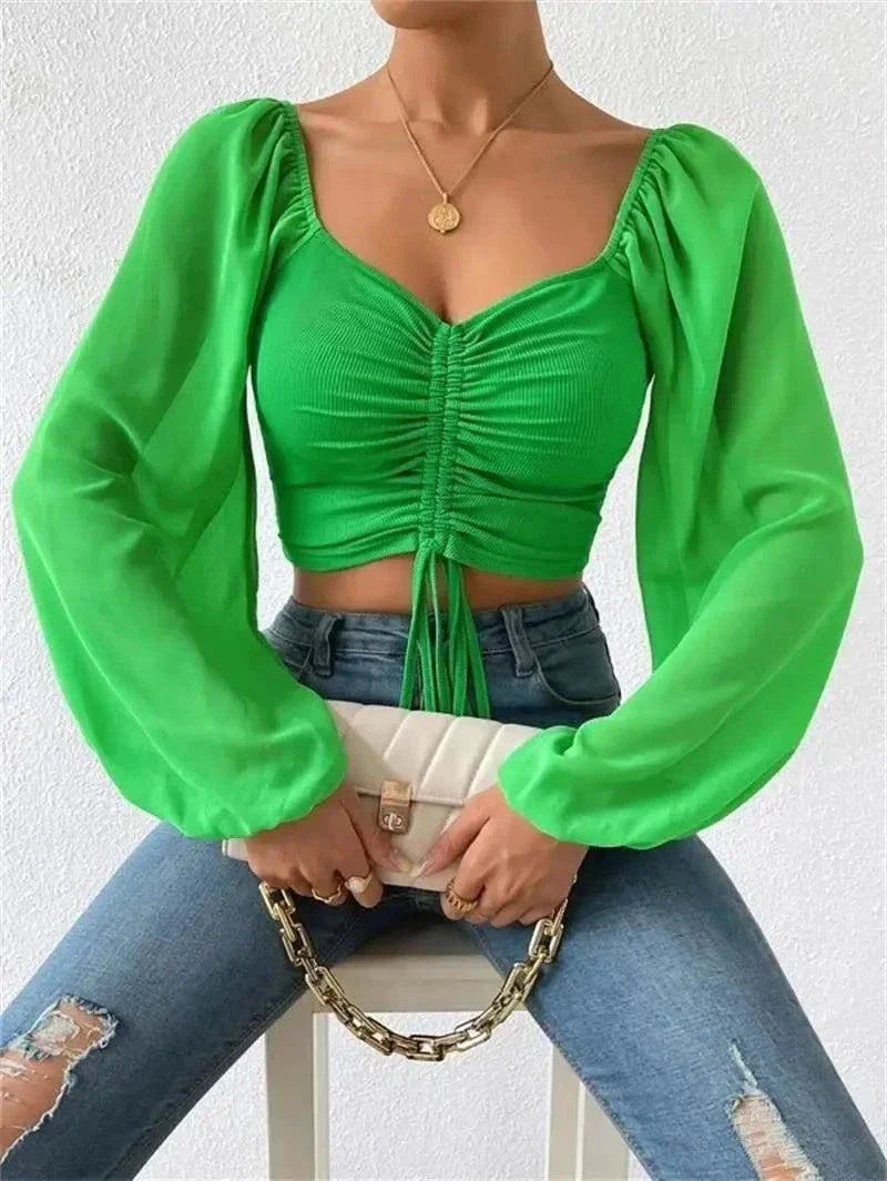 Chic green V-neck crop tee with drawstring design and long sleeves.