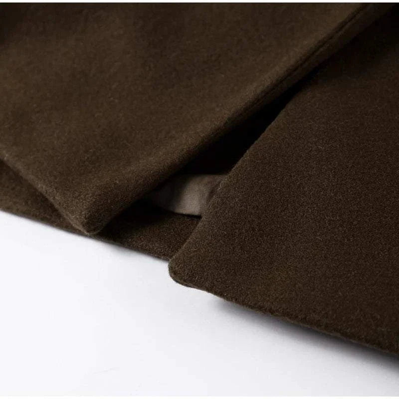 Close-up of brown wool blend fabric on a double-breasted overcoat, designed for autumn and winter.