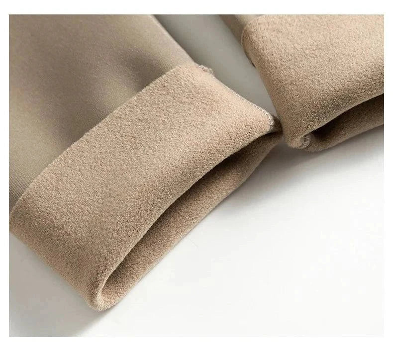 Close-up of beige thin rabbit fleece leggings with soft interior lining for warmth.