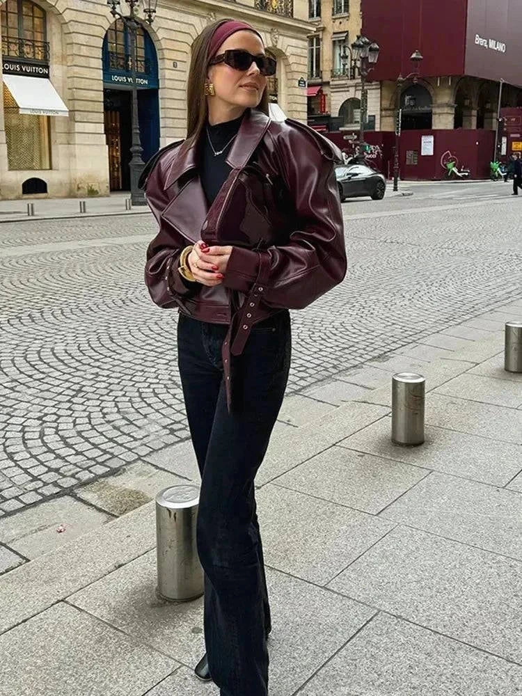 Vintage cropped leather jacket with braid lapel and zipper, casual retro style for women.