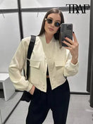 Switch Women&#39;s chic vintage-inspired bomber jacket with pockets, long sleeves, front button closure, and a stylish casual silhouette. 1 image