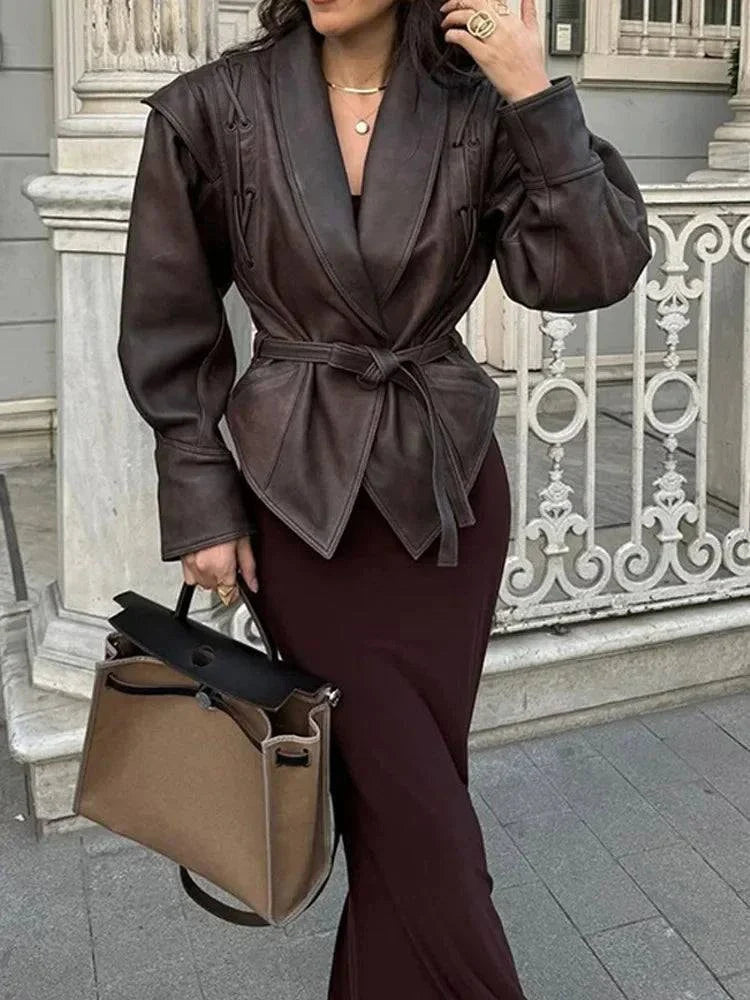 Vintage lapel leather jacket for women with long sleeves, lace-up details, in solid color, styled with a handbag, perfect for autumn fashion streetwear.