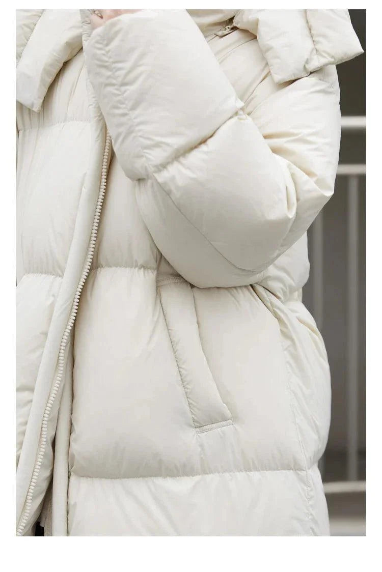 Women's long down coat, cream color, thick and soft, with detachable hood and full zipper closure, perfect for warm autumn and winter wear.