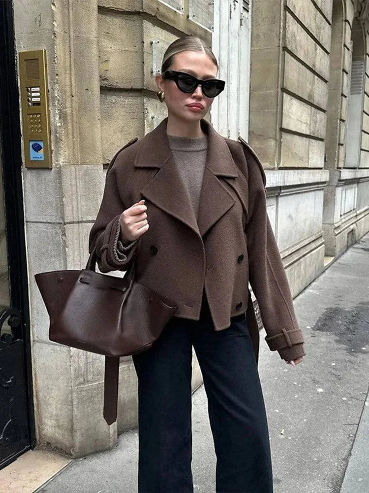 Elegant brown woolen overcoat with double-breasted design and adjustable belt.