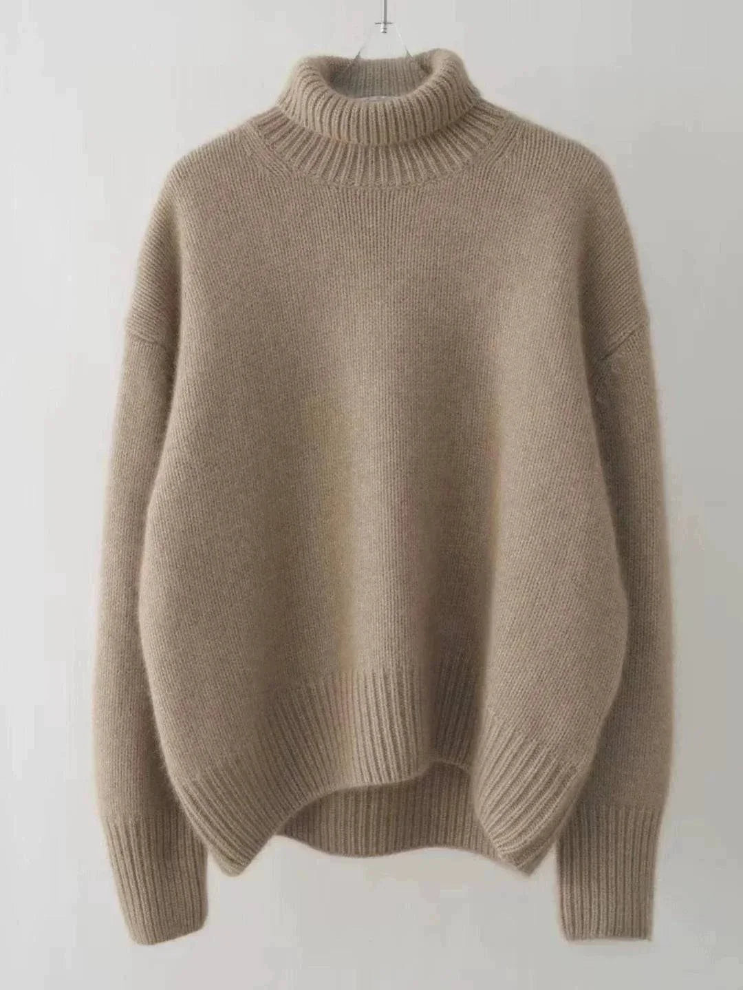 Women's loose turtleneck cashmere sweater, winter wool jumper, in beige color, elegant and comfortable design.