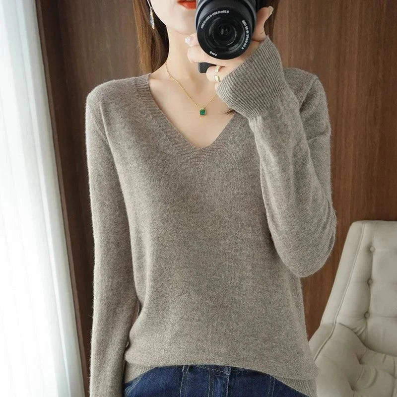 Cashmere V-neck women's pullover sweater with long sleeves and intricate lace neck detailing.