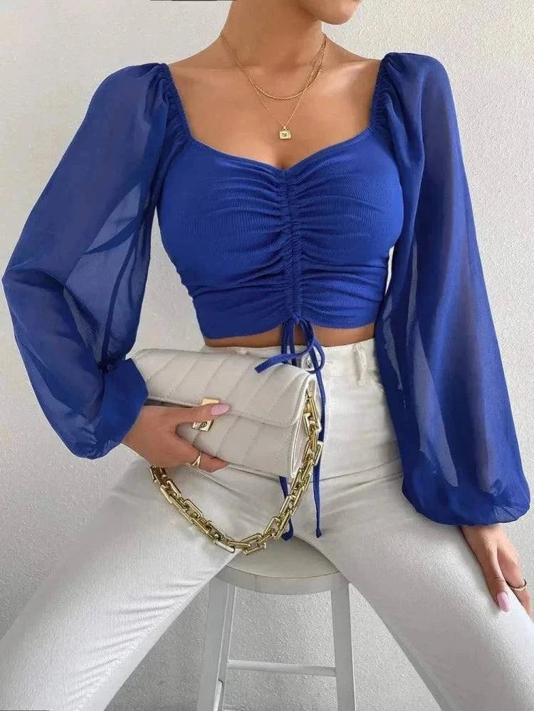 Blue V-neck crop tee with long sleeves and drawstring design.