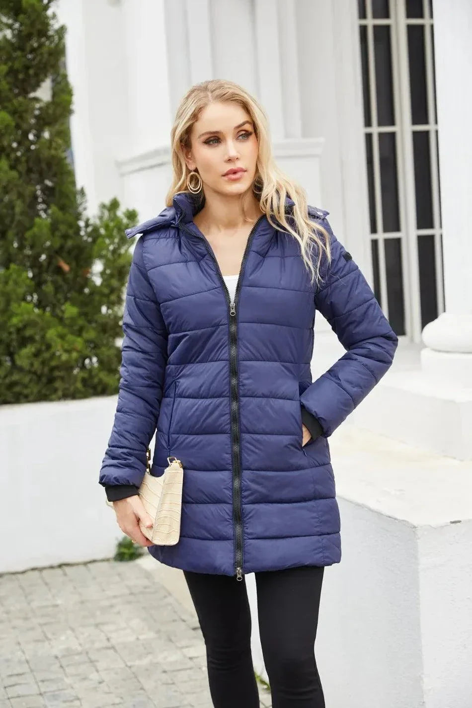 Women's blue waterproof parka with detachable hat and full-length zipper, perfect for autumn and winter.