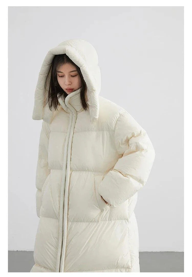 Long white women's down coat with detachable hood, ideal for autumn and winter.