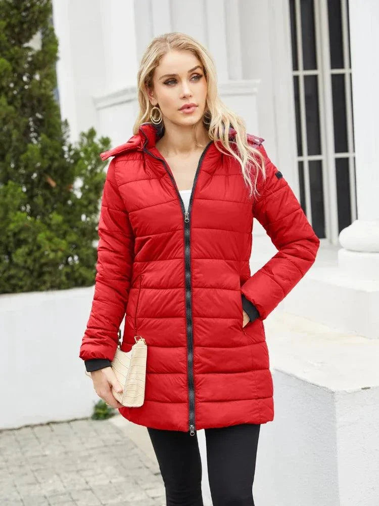 Women's red waterproof parka with detachable hat, long sleeves, and full-length zipper for autumn and winter.