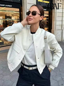 Switch Women&#39;s vintage-inspired white bomber jacket with pockets and front button closure, ideal for casual chic layering. 2 image