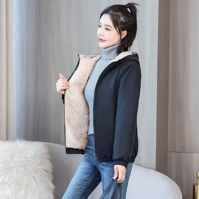 Women's winter fleece hooded jacket with plush lining, designed for warmth and style during cold weather.