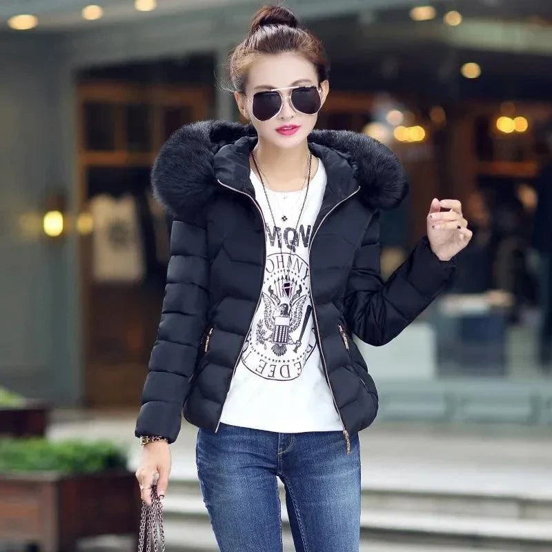 Women’s black winter parka with artificial raccoon fur collar, stylish and cozy for 2024 season.