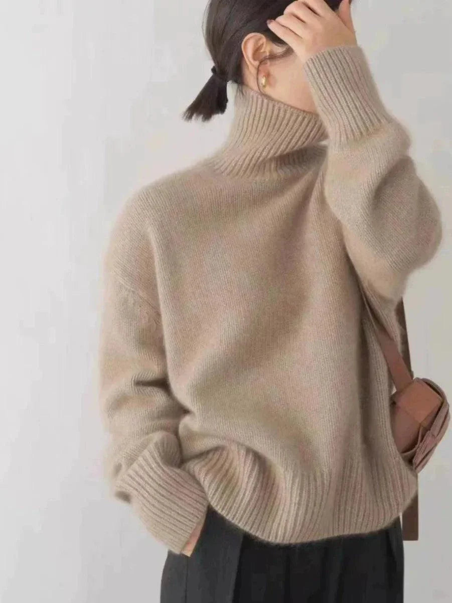 Women's loose turtleneck cashmere sweater in beige, perfect for autumn and winter.