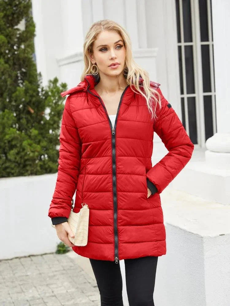 Women's red waterproof parka with detachable hat and long sleeves.