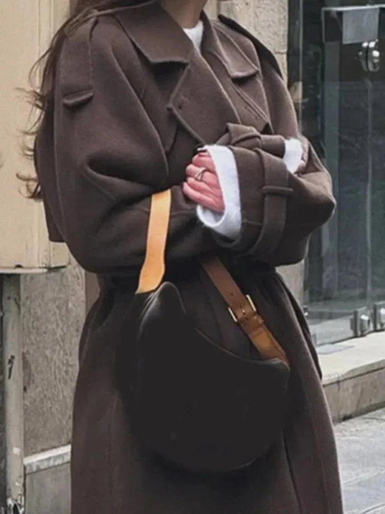 Elegant brown woolen overcoat with double-breasted design and adjustable belt, perfect for autumn fashion.