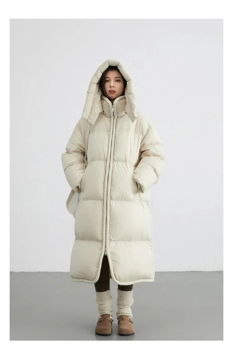 Women's long down coat with detachable hood, full zipper closure, and solid design, ideal for autumn and winter warmth.