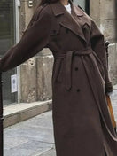 Switch Elegant brown woolen overcoat with double-breasted design and adjustable belt. 2 image