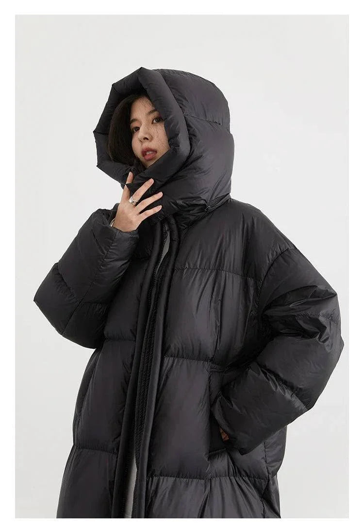 Women's long black down coat with detachable hood, ideal for autumn and winter 2023, featuring thick soft insulation and full-length zipper for warmth and style.