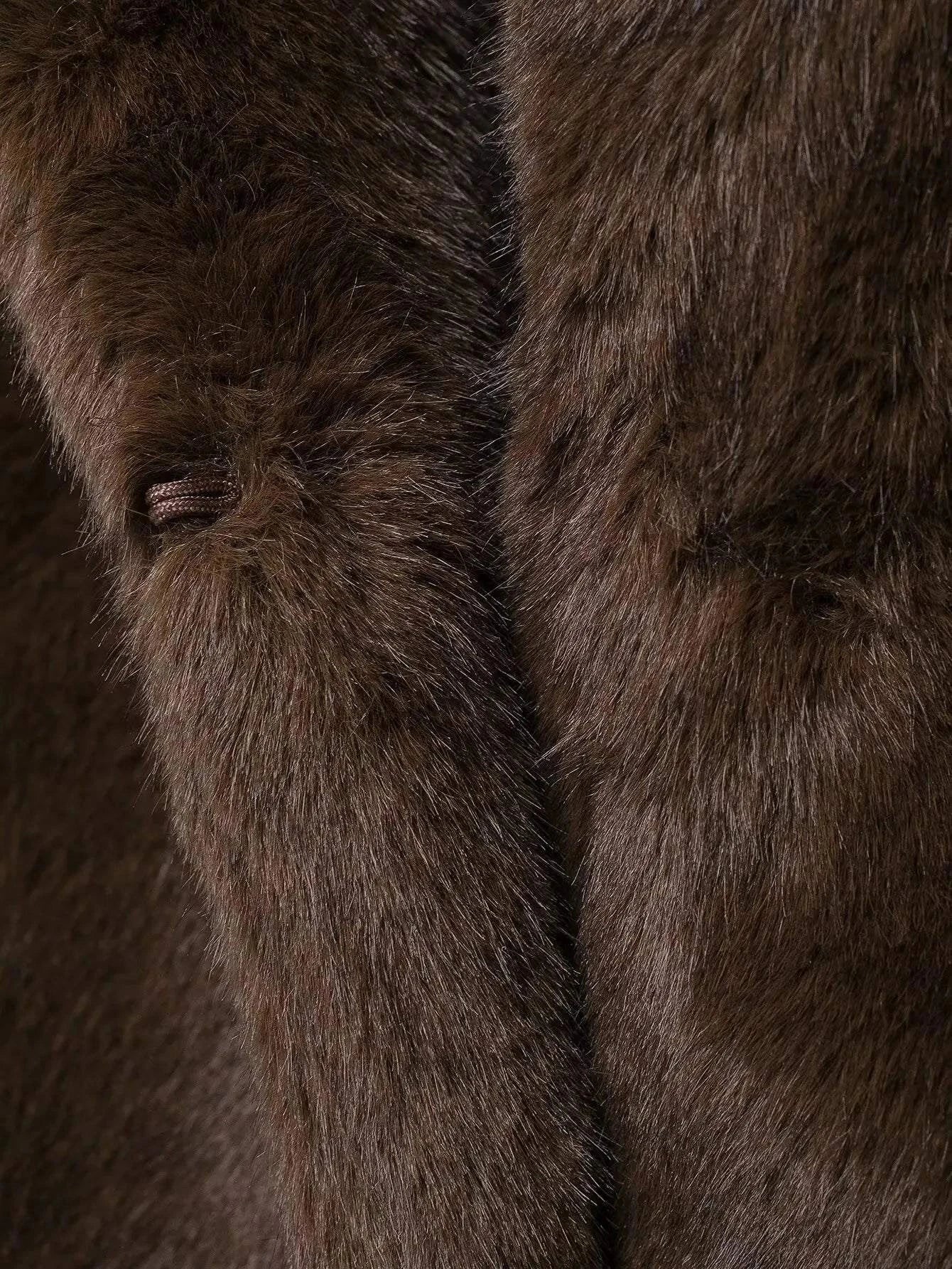 Close-up view of brown fleece fabric on a winter women's jacket.