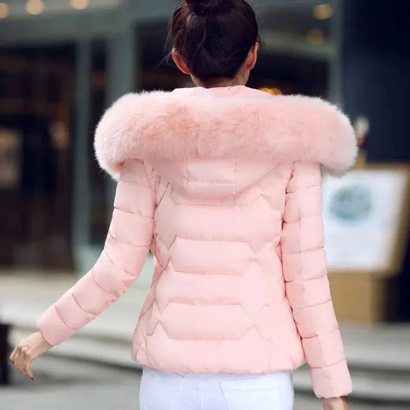 Women's artificial raccoon fur collar winter jacket in pink, stylish parka for 2024 winter fashion.