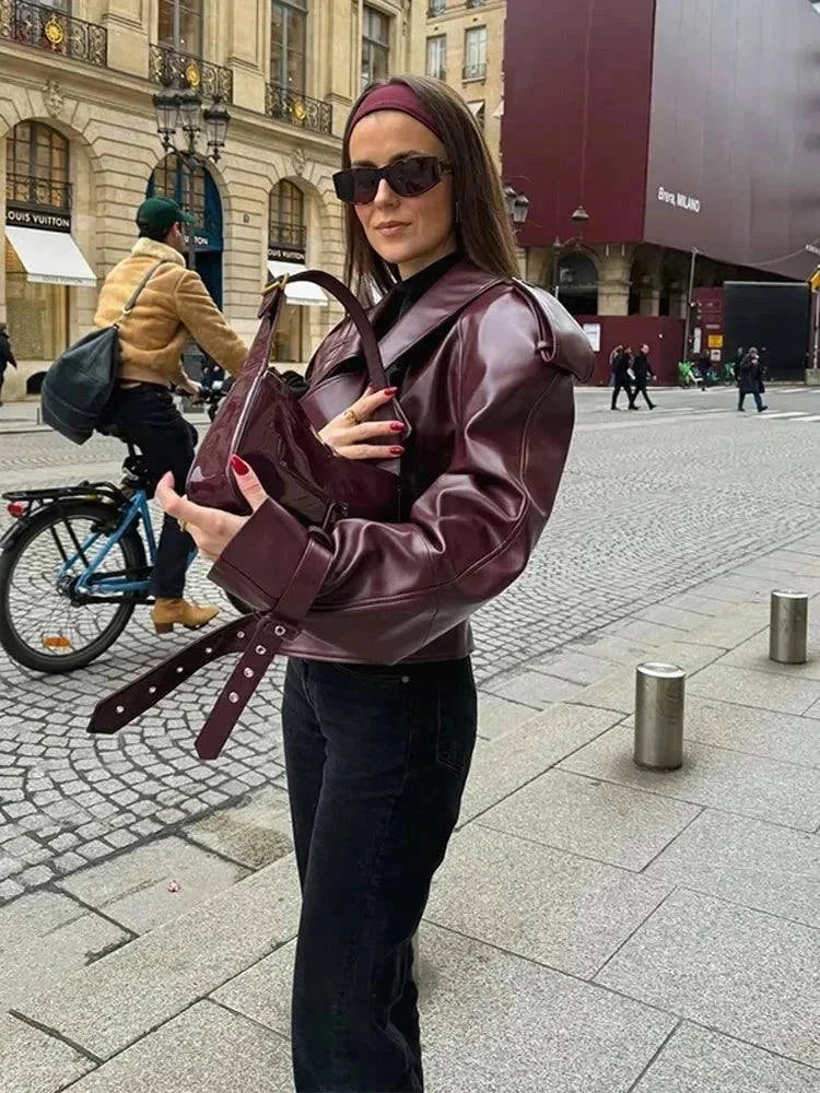 Vintage cropped leather jacket with braid lapel, worn by woman on city street, Alfadarling.