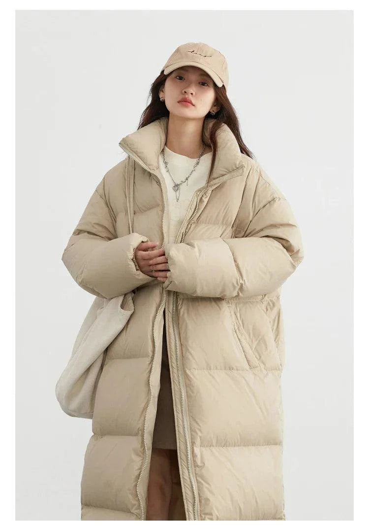 Women’s long down coat, thick and warm for autumn/winter; loose casual jacket; solid color; stylish and comfortable.