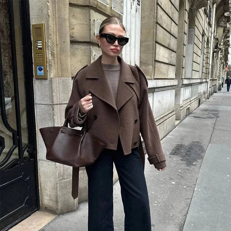 Elegant brown woolen overcoat for autumn, double-breasted design with loose lapel and adjustable belt.