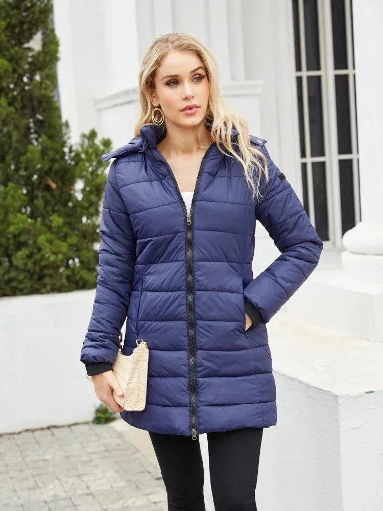 Women's blue waterproof parka with detachable hat, long sleeves, and full-length zipper for autumn and winter.