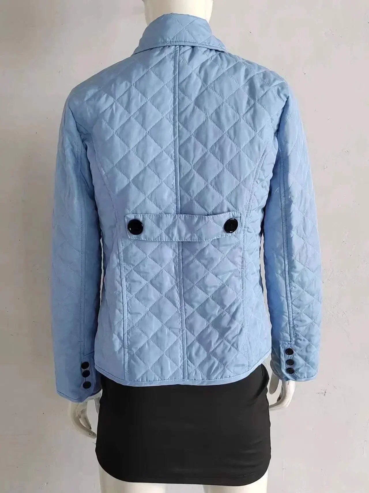 Quilted winter coat for women with single-breasted closure and turn-down collar, stylish mid-thigh length jacket.