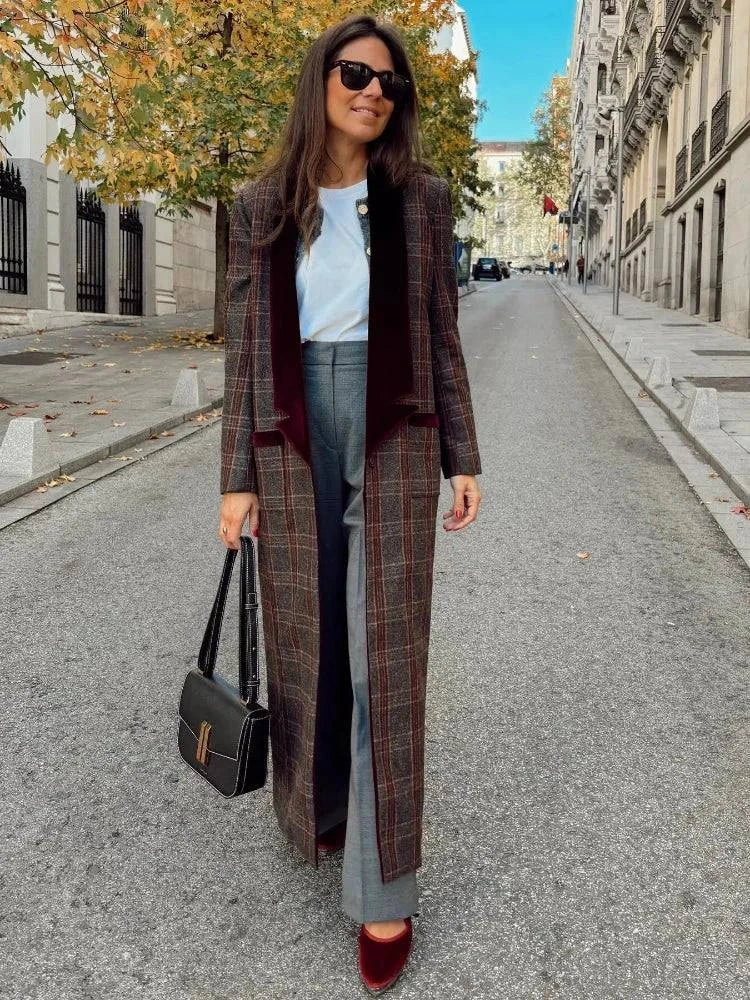 Women wearing a colorful plaid woolen overcoat with a stylish turn-down collar, walking down a city street.