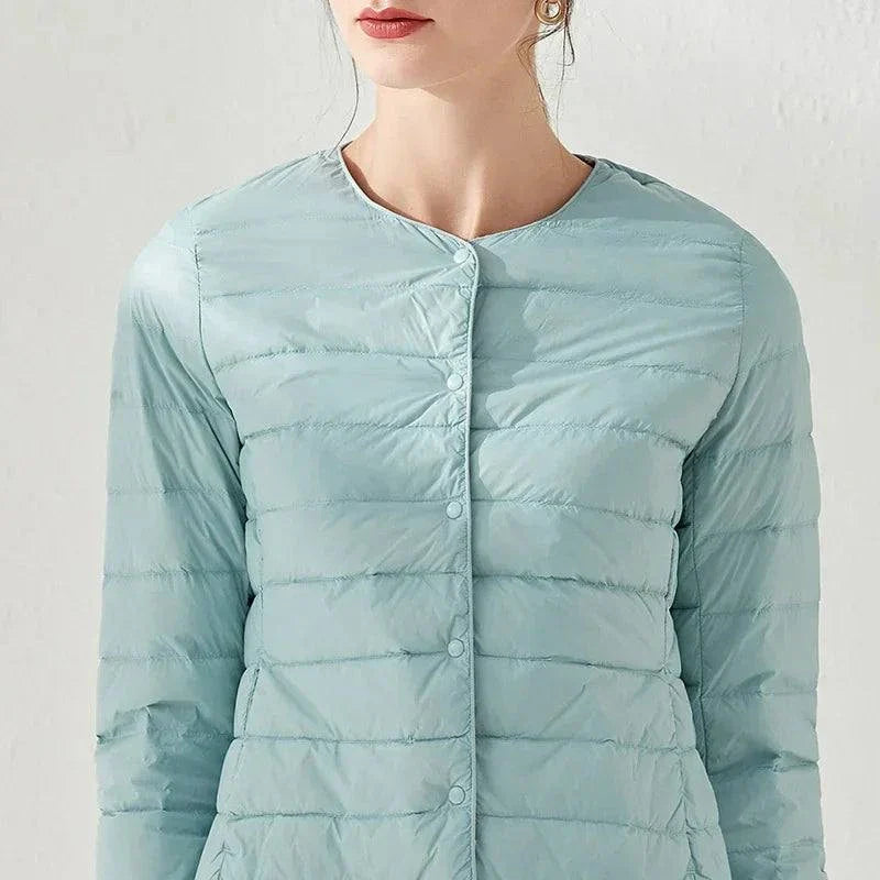 Ultralight warm women’s puffer jacket, collarless design, O-neck, Alfadarling, premium down filling, light blue color.