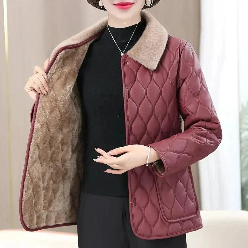 Wine red plush winter jacket for women with fur collar and velvet fabric.